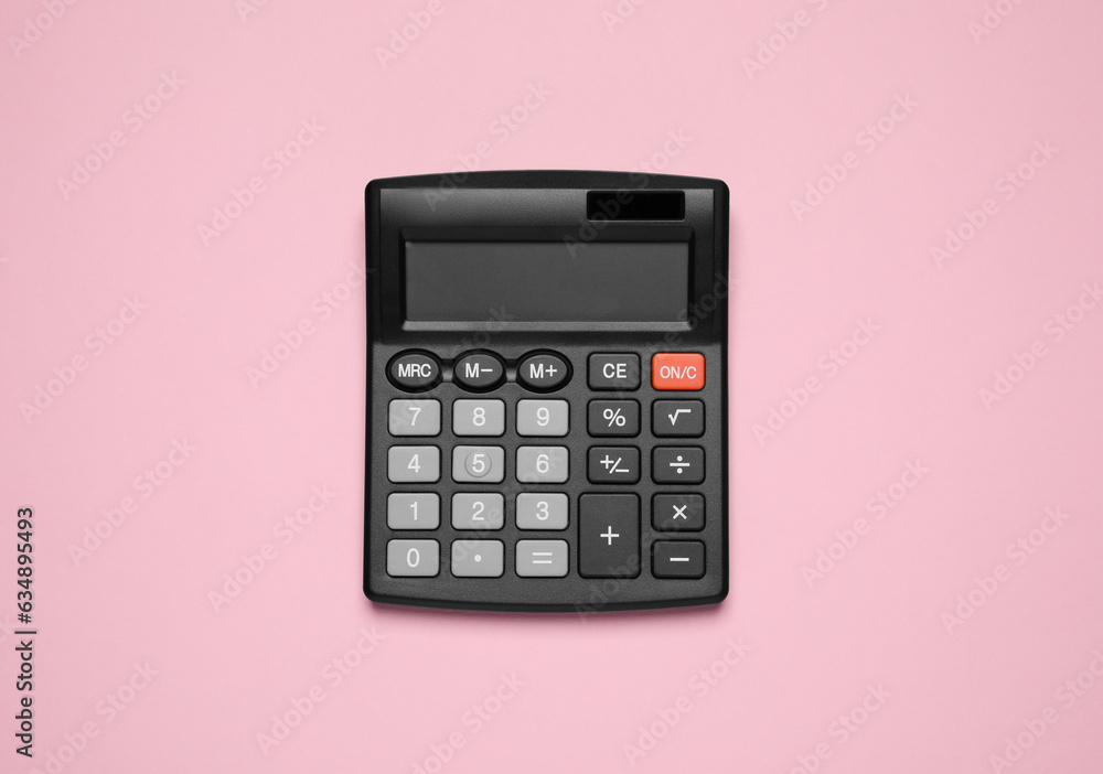 Calculator on pink background, top view. Office equipment Calculator on pink background, top view. Office equipment