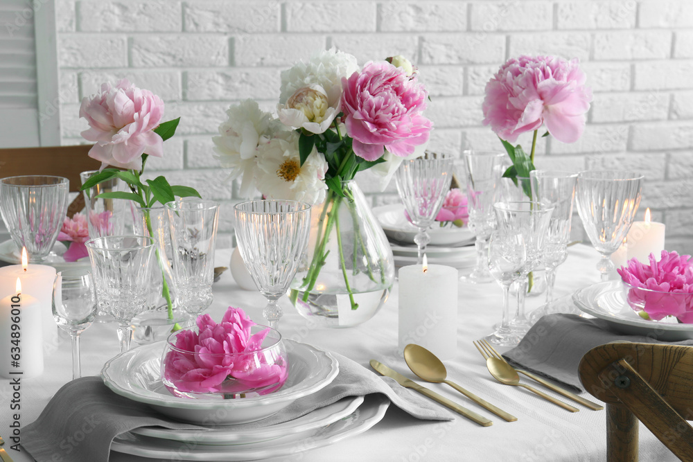 Stylish table setting with beautiful peonies in dining room