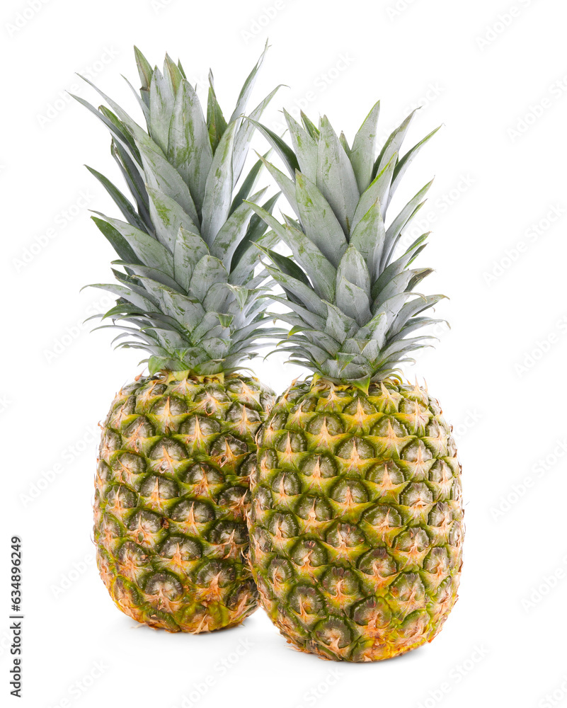 Fototapeta premium Two delicious ripe pineapples isolated on white