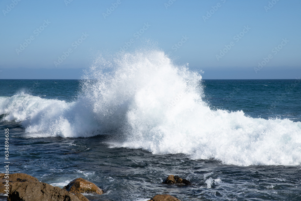 waves crashing on rocks in california