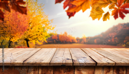 wooden table in front of a colorful autumn landscape, beautiful autumn background concept with fall leaves and advertising space photo