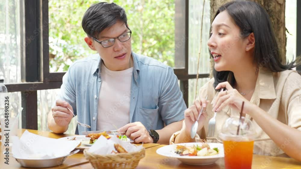 4K Happy Asian couple and elderly father having lunch eating meal together at cafe restaurant on summer holiday vacation. Family relationship, father's day and old senior people health care concept. 4K Happy Asian couple and elderly father having lunch eating meal together at cafe restaurant on summer holiday vacation. Family relationship, father's day and old senior people health care concept.