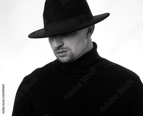 portrait of a young man in a black hat. White background. 