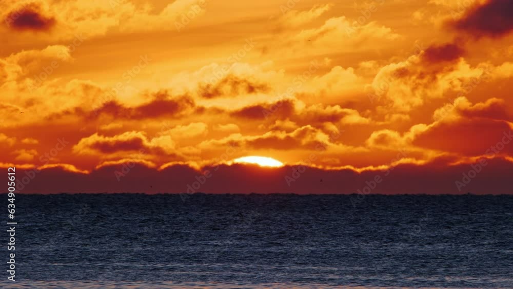 Dramatic sunset over sea. Burning sky and shining waves. Warm clouds and pure ocean water at sunrise. Nature cinematic seascape. Dramatic sunset over sea. Burning sky and shining waves. Warm clouds and pure ocean water at sunrise. Nature cinematic seascape.