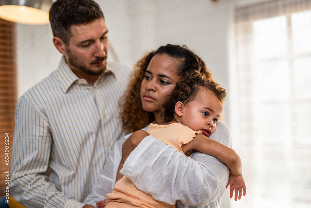 African American mother tosses young baby girl up in living room at home. African American mother tosses young baby girl up in living room at home.