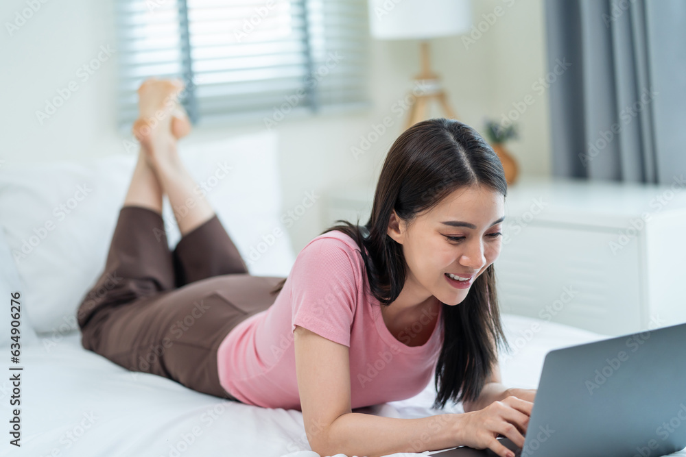 Asian attractive woman using laptop chat on bed at home in the morning. Asian attractive woman using laptop chat on bed at home in the morning.