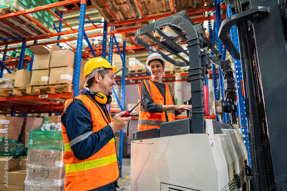 Caucasian man and woman industrial worker work in manufacturing plant. Caucasian man and woman industrial worker work in manufacturing plant.