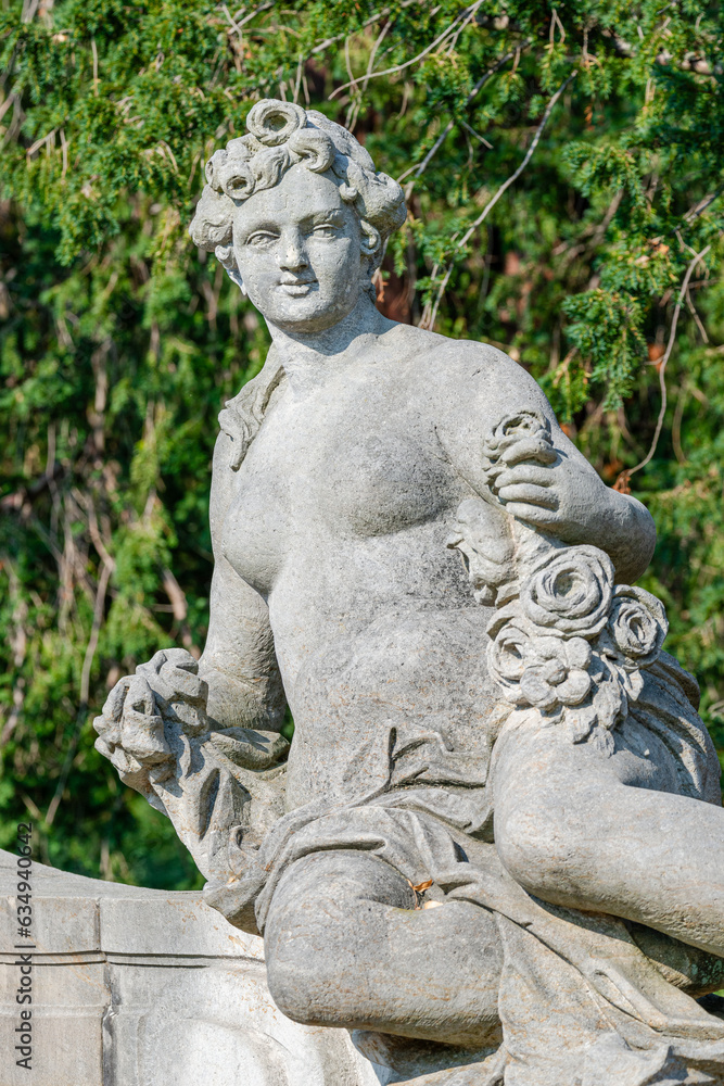 Potsdam, Germany - Old statue of a sensual Renaissance era woman after bathing in the city park and gardens of Potsdam, details, closeup.