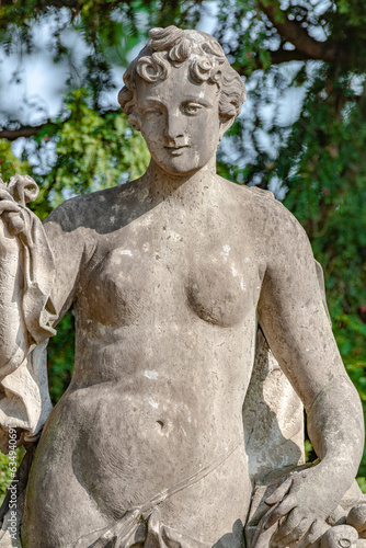 Potsdam  Germany - Old statue of a sensual Renaissance era woman after bathing in the city park and gardens of Potsdam  details  closeup.