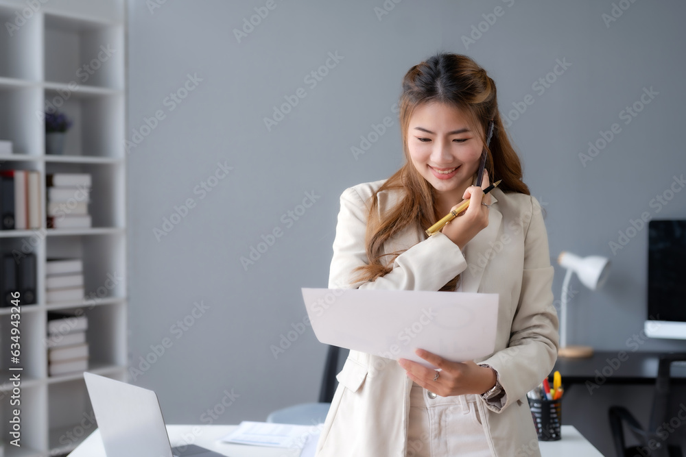 Asian businesswoman modern professional talking with client on the phone with a confident demeanor and effective communication skill. business, marketing, sale and communication project. Asian businesswoman modern professional talking with client on the phone with a confident demeanor and effective communication skill. business, marketing, sale and communication project.