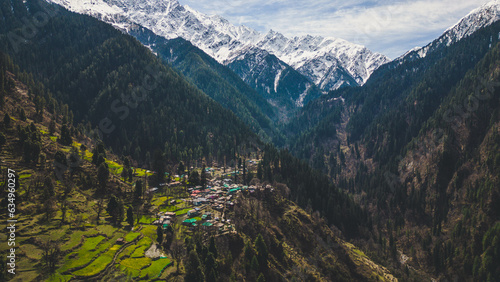 aerial view of Grahan Village - India's Most Beautiful and Hidden village at Himalayas mountains surrounded by snow mountain - Kasol, India photo