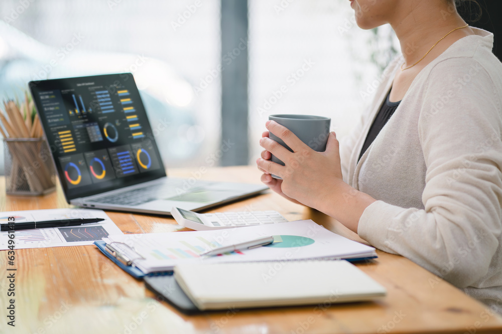 The female analyst utilizes a computer and a dashboard for business data analyze and a data management system with KPI. The concepts of technology, finance, operations, sales, and marketing.
