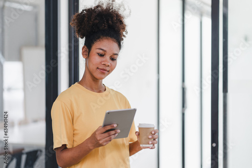 Cheerful young African American pretty woman, entrepreneur in casual wear, smiling, using smartphone in a modern office. Free Download Cheerful young African American pretty woman, entrepreneur in casual wear, smiling, using smartphone in a modern office. - GFXLoad