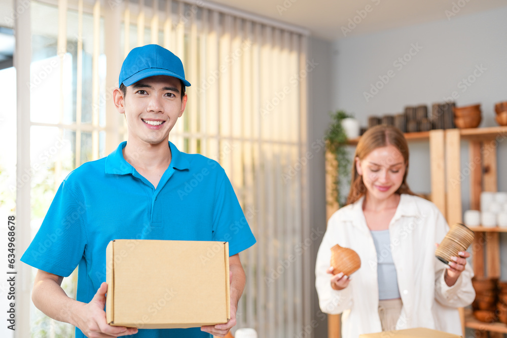 Make money online with e-commerce seller girl and use quality delivery service shipping online order for worldwide international customer while worker man carrying parcel product box in workplace Make money online with e-commerce seller girl and use quality delivery service shipping online order for worldwide international customer while worker man carrying parcel product box in workplace