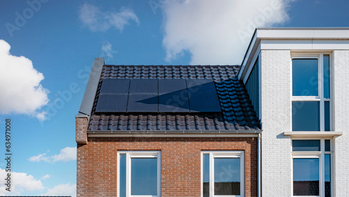 Newly build houses with solar panels attached on the roof ,Solar photovoltaic panels on a house roof