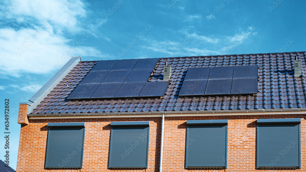 Newly build houses with solar panels attached on the roof , Solar panel on a roof Newly build houses with solar panels attached on the roof , Solar panel on a roof