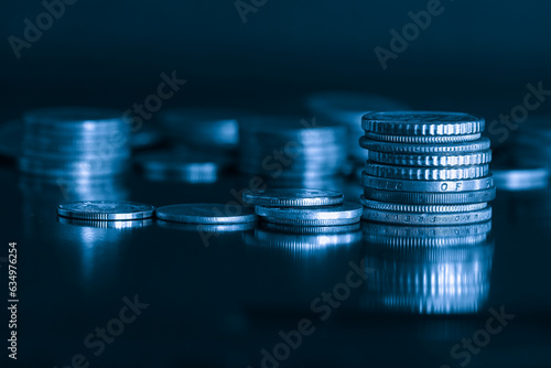 close up Stack of money coin on black background with blue filter. Business and finance concept.