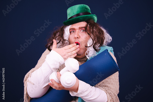 Healthy lifestyle. Funny drag queen is doing fitness and posing with different emotions on a blue background. photo