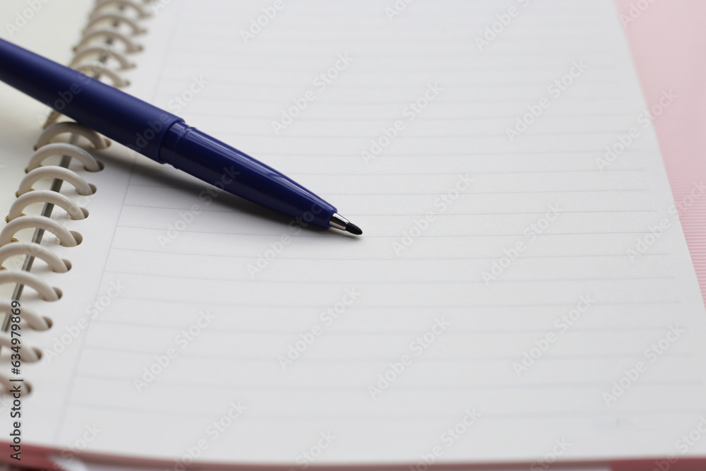 Notebook with pen on pink background. Work planning Notebook with pen on pink background. Work planning