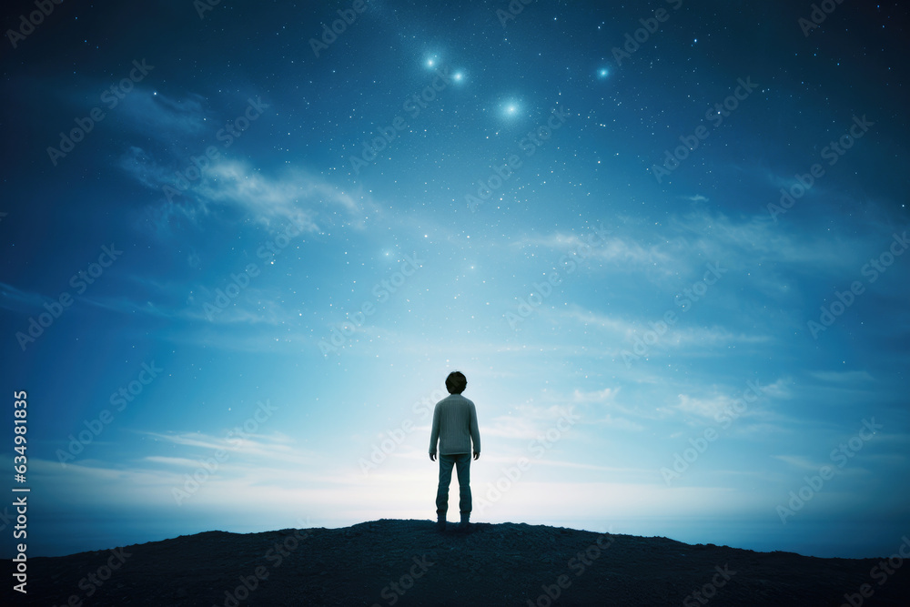 Man standing on top of mountain and looking at starry sky