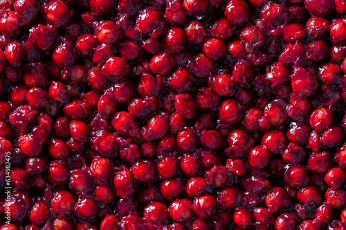 Lots of sour cherry pits as a background closeup. Texture of dried cherry kernels. Top view photo