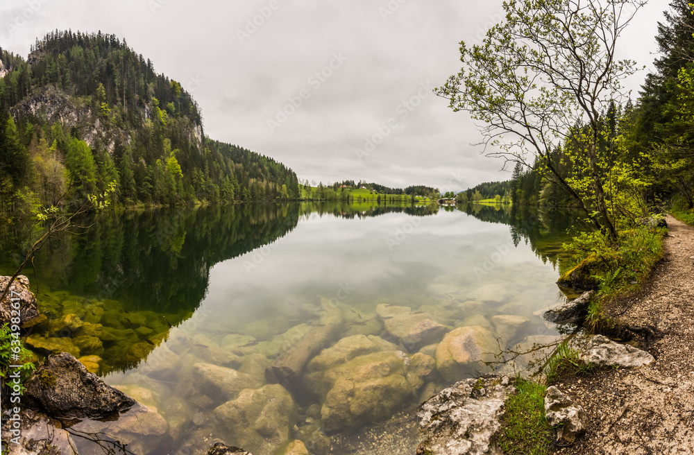 huge rocks in a mountain lake with wonderful reflections from the landscape panorama huge rocks in a mountain lake with wonderful reflections from the landscape panorama