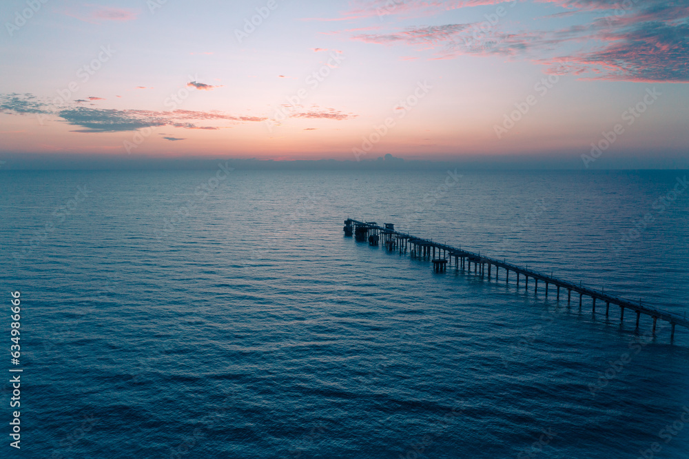 aerial drone view of oil jetty at morning sunrise over the  sea in the east of Thailand.
