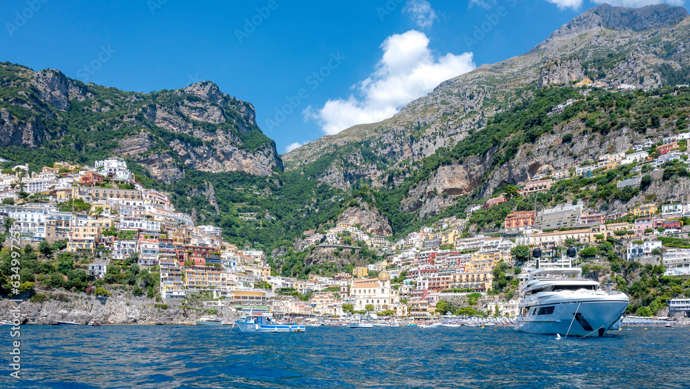 Naklejka premium beach and Positano's city seen from the sea in a summer day. Amalfi coast, Italy.