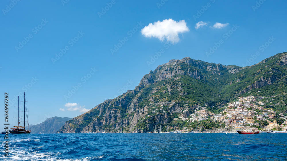 Positano and Amalfi coast seen from the sea with a sailing ship. Italy.