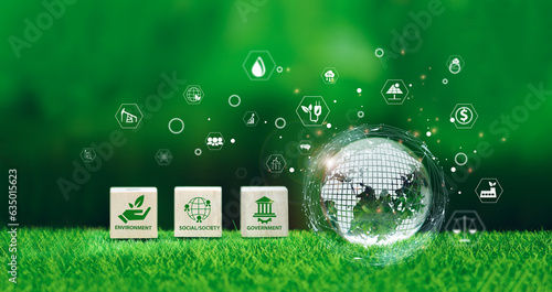 Glass globe in green forest with the icon environment of ESG, co2, circular company, and net zero. Technology Environment, Organization Sustainable development environmental.	 photo