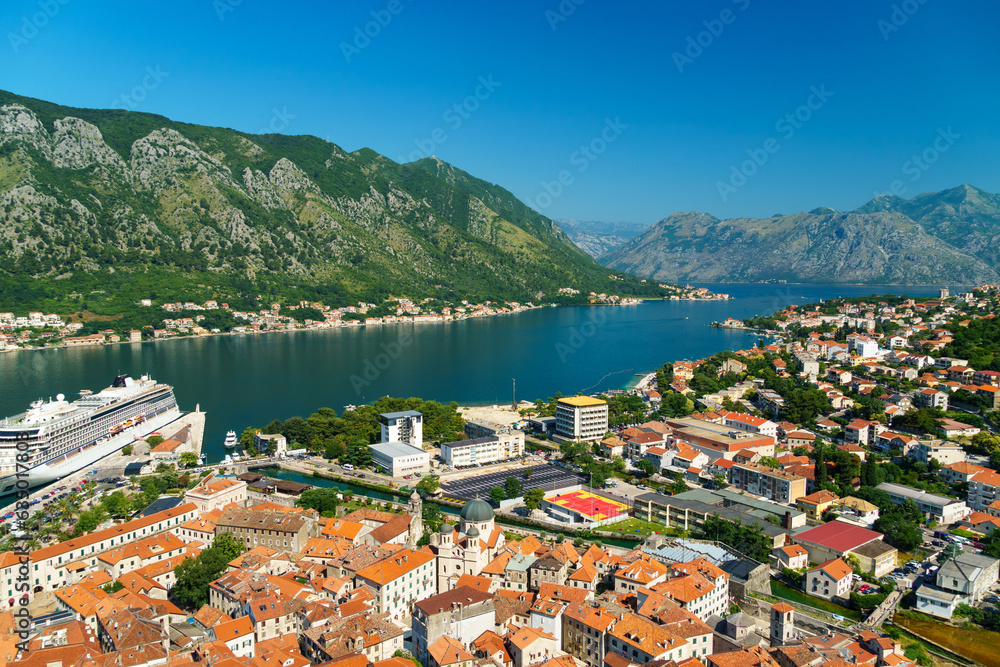 view of the old town of Kotor in Montenegro and the coast of the Bay of Kotor, the sea and medieval European architecture, red tiled roofs, the concept of traveling across the Balkans