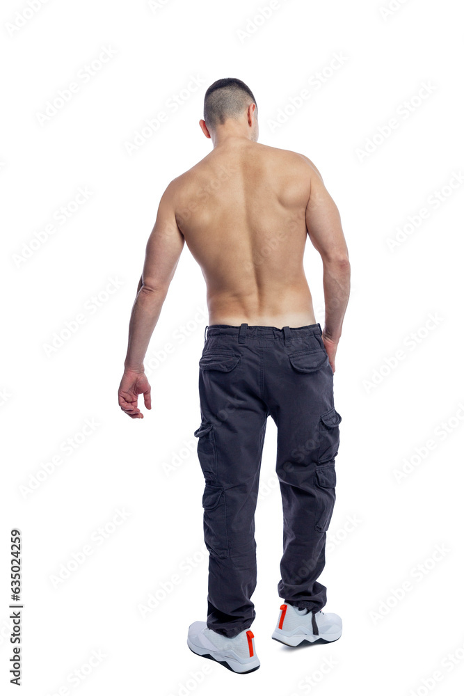 A man with a beautiful athletic figure in trousers with a naked torso stands in full growth. Sport and health. Isolated on white background. Vertical. Back view. A man with a beautiful athletic figure in trousers with a naked torso stands in full growth. Sport and health. Isolated on white background. Vertical. Back view.