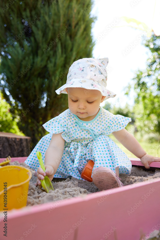 baby girl playing in sand on outdoor playground baby girl playing in sand on outdoor playground