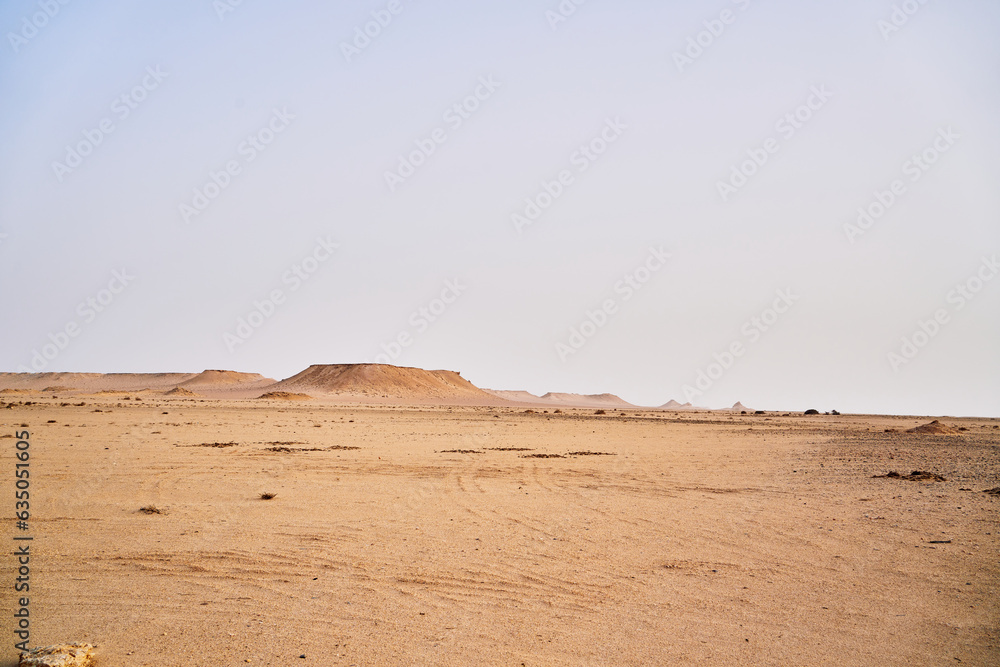 A view of some of the desert landscape with rocks formation sand and hills.