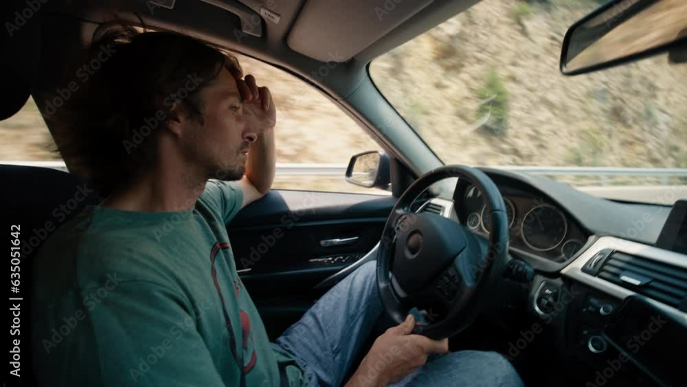 Tired man driving vehicle on long vacational road trip Tired man driving vehicle on long vacational road trip