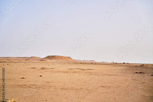 A view of some of the desert landscape with rocks formation sand and hills.