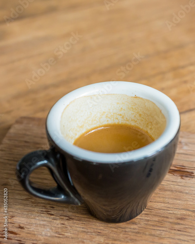 coffee espresso shot in a cup on a wooden table