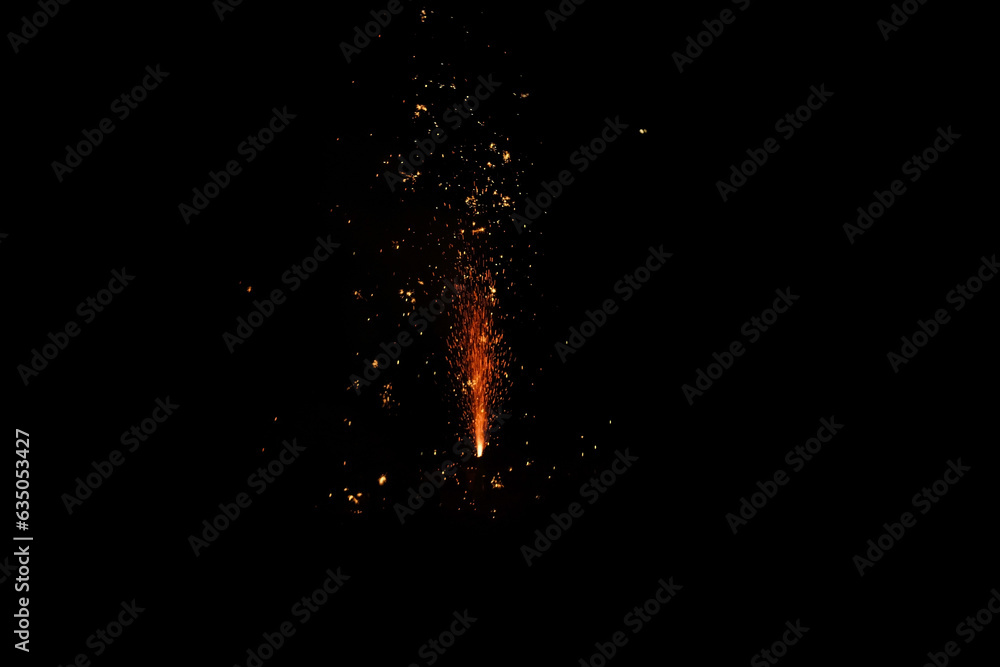 black background with bright sparks fireworks, Christmas glowing dust, Sparkler or bengal festive light effect for designer, lights effect background