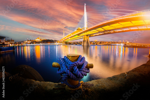 New Halic Metro Bridge at summer night blue sky and city lights in Istanbul, Turkey photo