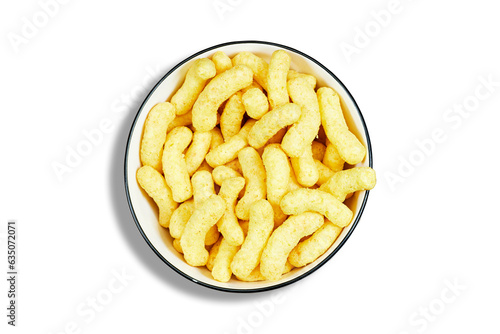 Peanut flips, in a ceramic bowl on wooden table . Also known as Bamba, peanut puffs or snips, is a puffed, peanut-flavored corn snack