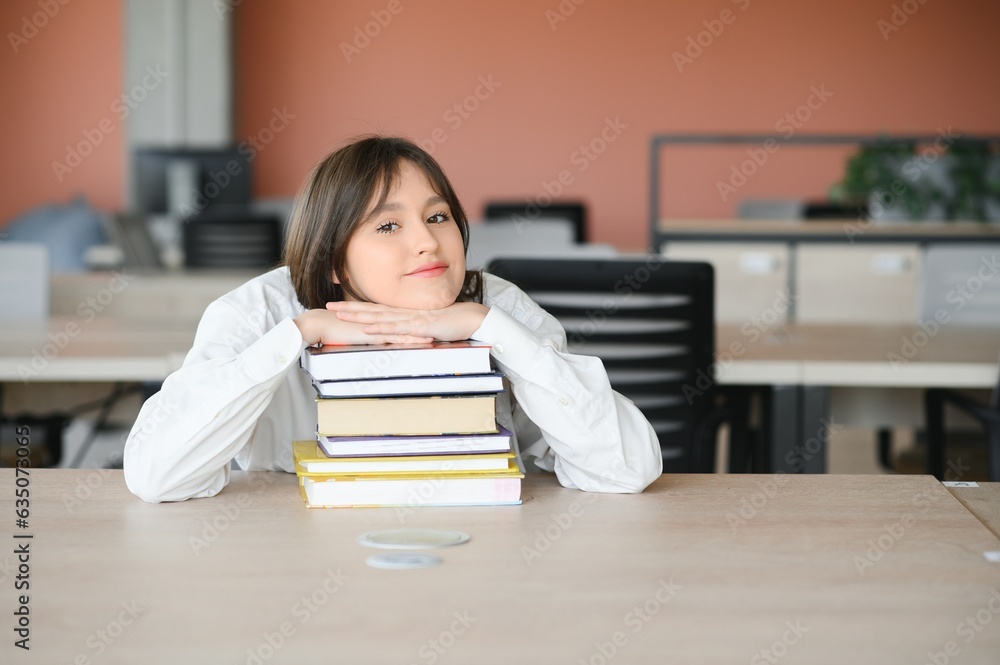 education and school concept - student girl studying and reading book at school. education and school concept - student girl studying and reading book at school.