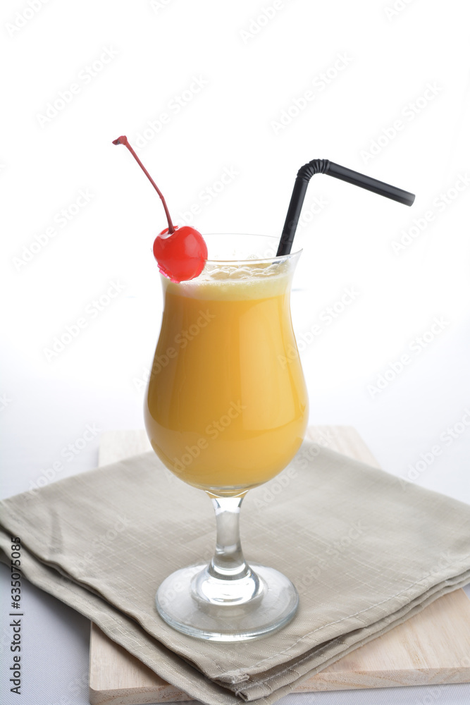 cold iced summer orange mango fruit juice with red cherry in cocktail glass black straw on grey cloth white background asian beverage halal food drink menu for hotel bar cafe cold iced summer orange mango fruit juice with red cherry in cocktail glass black straw on grey cloth white background asian beverage halal food drink menu for hotel bar cafe
