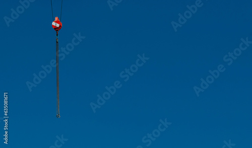 chain with crane hook on blue background 