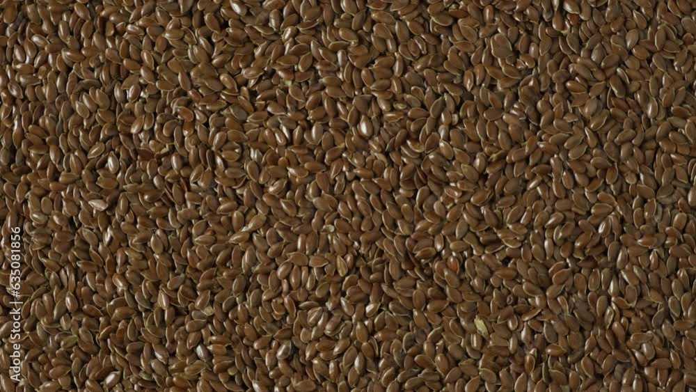 Flax seeds, closeup. 4K Video, rotating. Flaxseed or linseed is rich