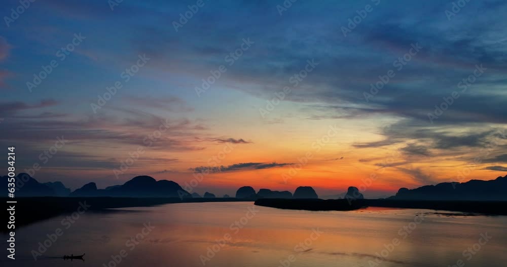 Aerial view colors of the sunrise reflect of the colorful clouds above the islands painting the sky in colorful colors shade..The reflection of sky on the ocean waters creates a stunning background Aerial view colors of the sunrise reflect of the colorful clouds above the islands painting the sky in colorful colors shade..The reflection of sky on the ocean waters creates a stunning background