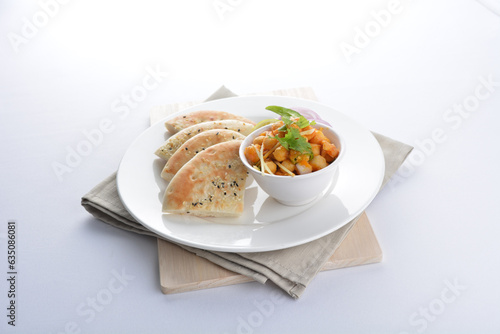 Indian vegetable bean curry sauce with baked naan pizza toast bread kebab breakfast on white background asian chef appetiser halal bakery food restaurant pastry menu for cafe