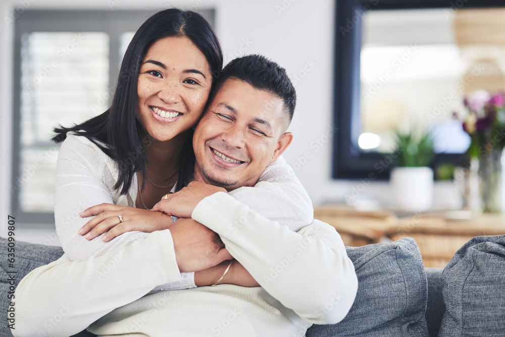 Happy, portrait and woman hugging her husband while relaxing on a sofa in the living room. Smile, love and face of an Mexican female person with a man in the lounge of their modern house together. Happy, portrait and woman hugging her husband while relaxing on a sofa in the living room. Smile, love and face of an Mexican female person with a man in the lounge of their modern house together.