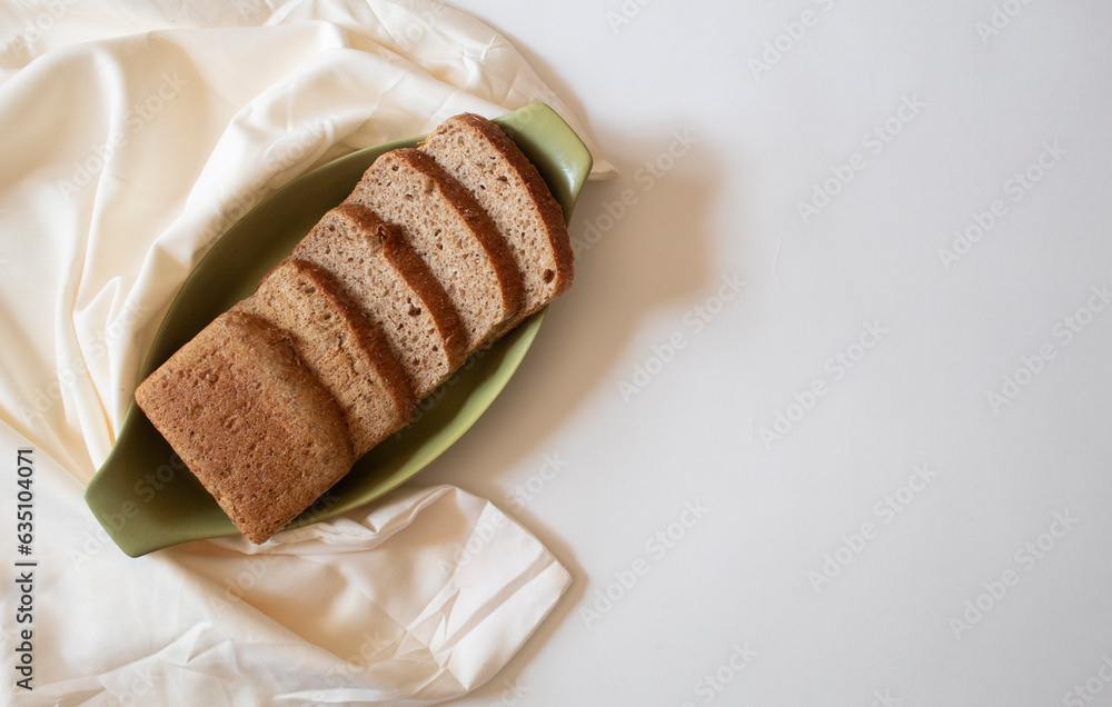 Brown bread slices on a white background flat lay Brown bread slices on a white background flat lay