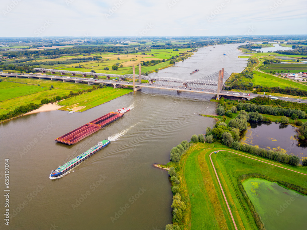 Aerial View on Cargo Ships sailing on the Waal River in The Netherlands