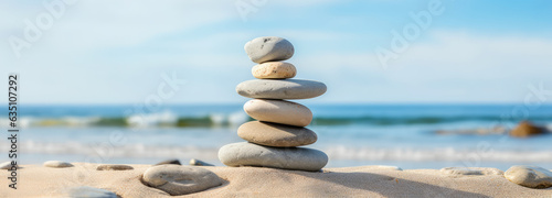 Some stones are stacked on a beautiful seaside sandy beach